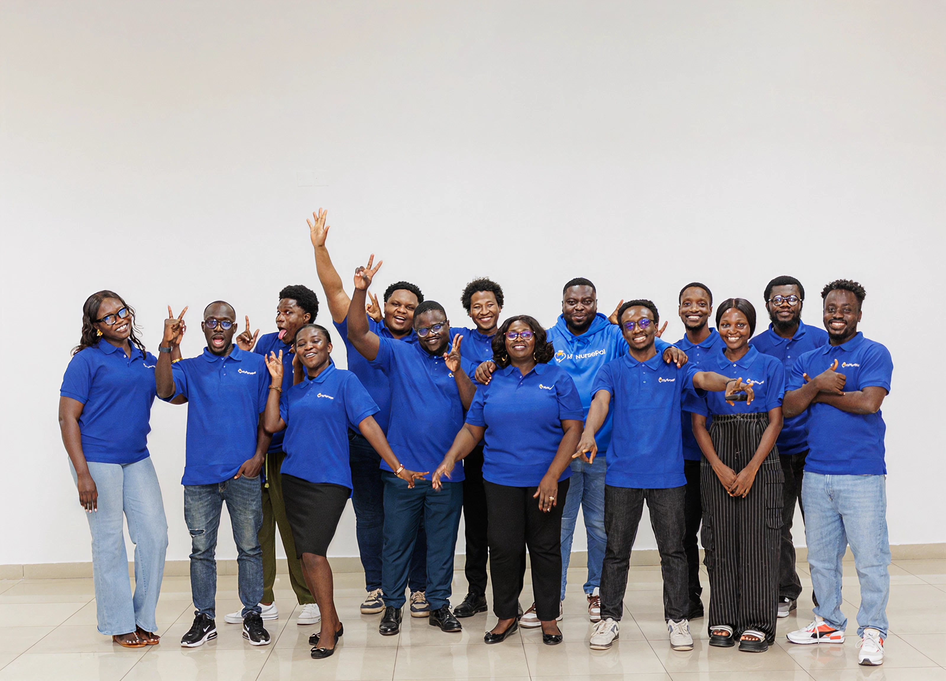 MyNursePal team members in matching blue shirts, smiling together.